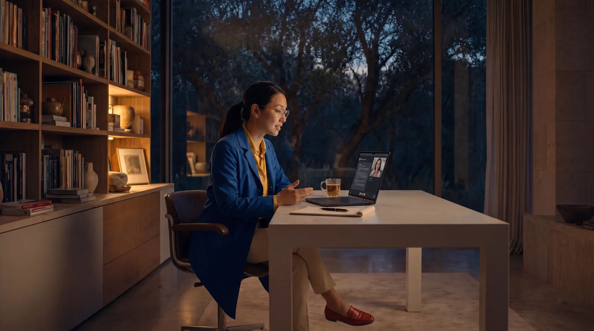 A Mindspan specialist on a video visit at her desk in the evening.